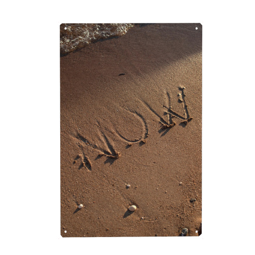 NOW sign in wet sand
