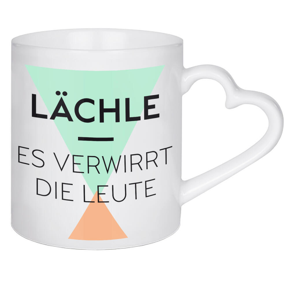 Herztasse "Lächle – Es verwirrt die Leute" artboxONE - Typografie - Pastell,Typografie,Spruch,Orange,Grün,Türkis,80er,Muster,Lächle,Leute,Dreieck