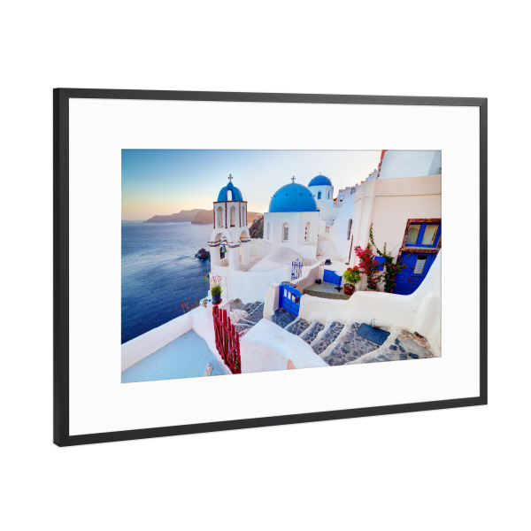 Poster mit Rahmen Schwarz (Metallic) "Oia town on Santorini island, Greece at sunset. Rocks on Aegean" artboxONE - Reise